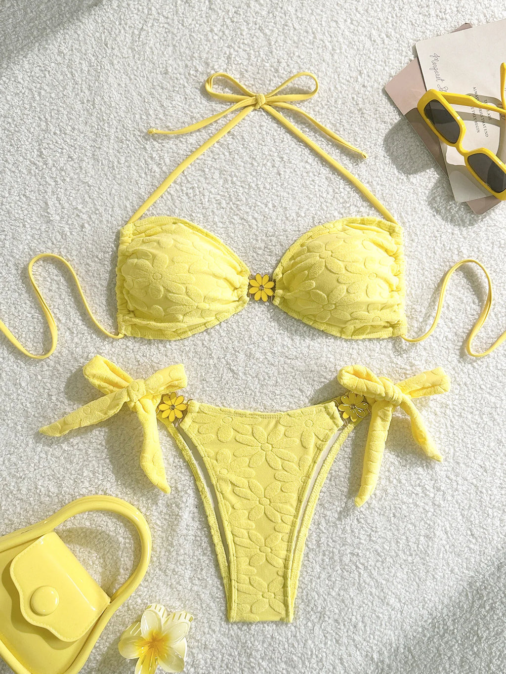 Yellow bikini set with matching accessories on a light background