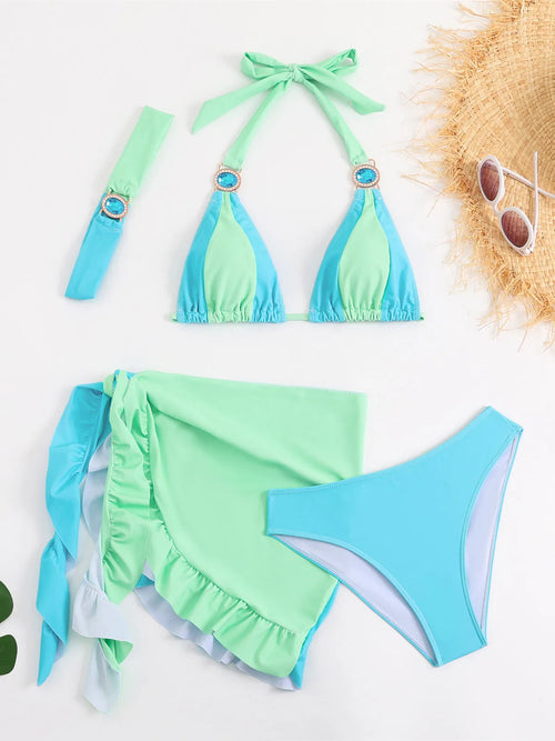 Green and blue bikini set with matching accessories on a white background